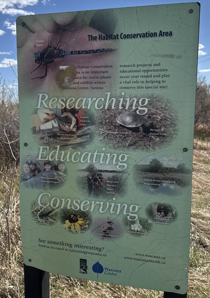 Researching, Educating, Conserving Educational sign explaining conservation, wildlife research, and environmental education efforts within the habitat conservation area.