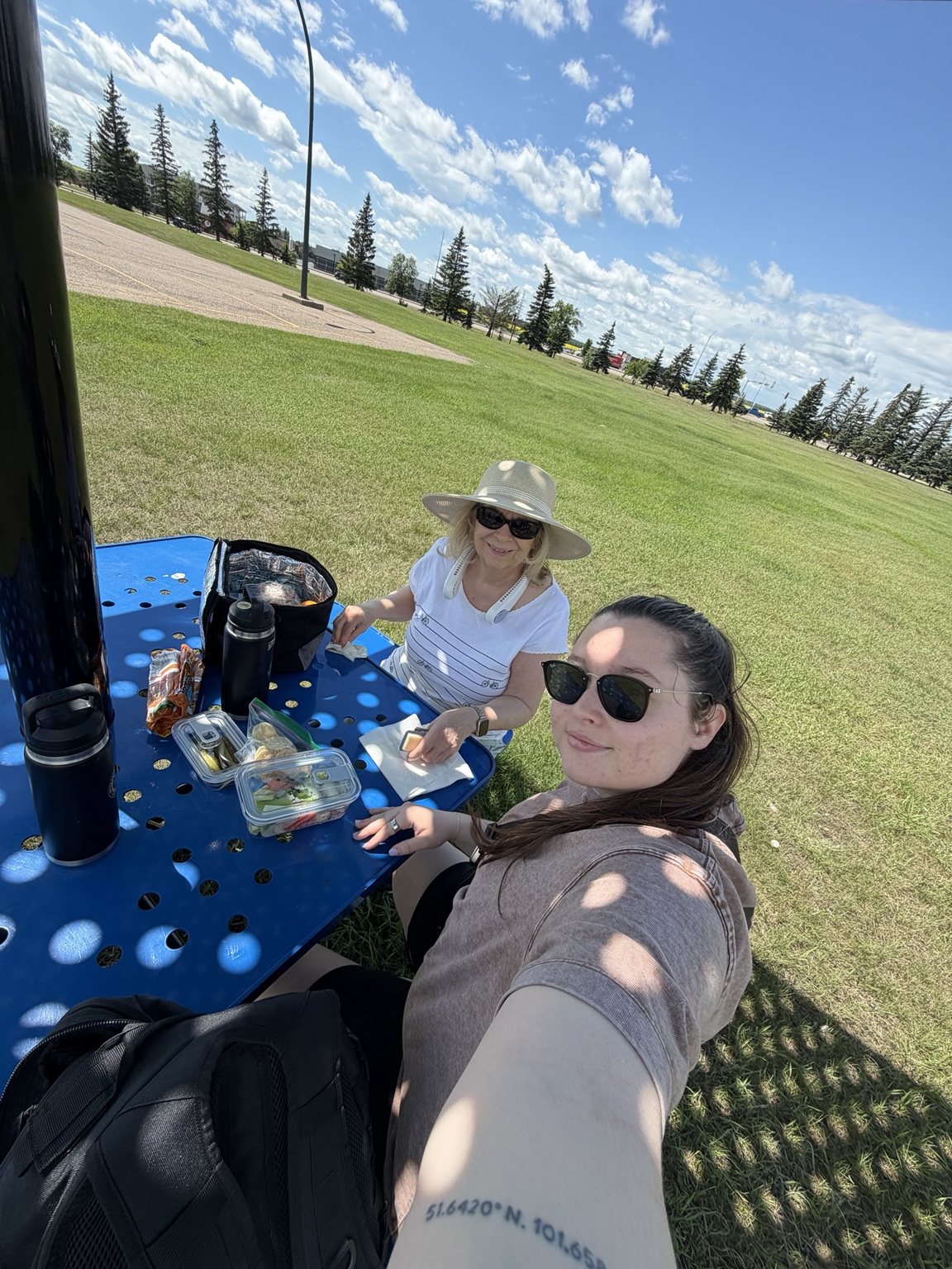 Grandmother and granddaughter eating lunch at the outdoor fitness park