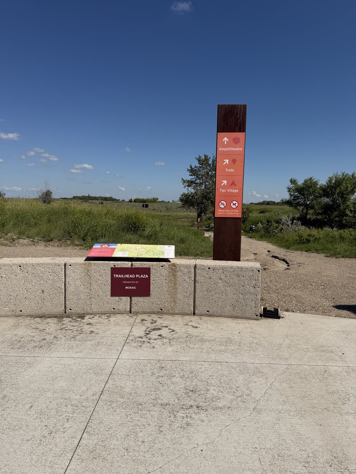 Wanuskewin trailhead plaza with directions to trails, tipi village and amphitheatre