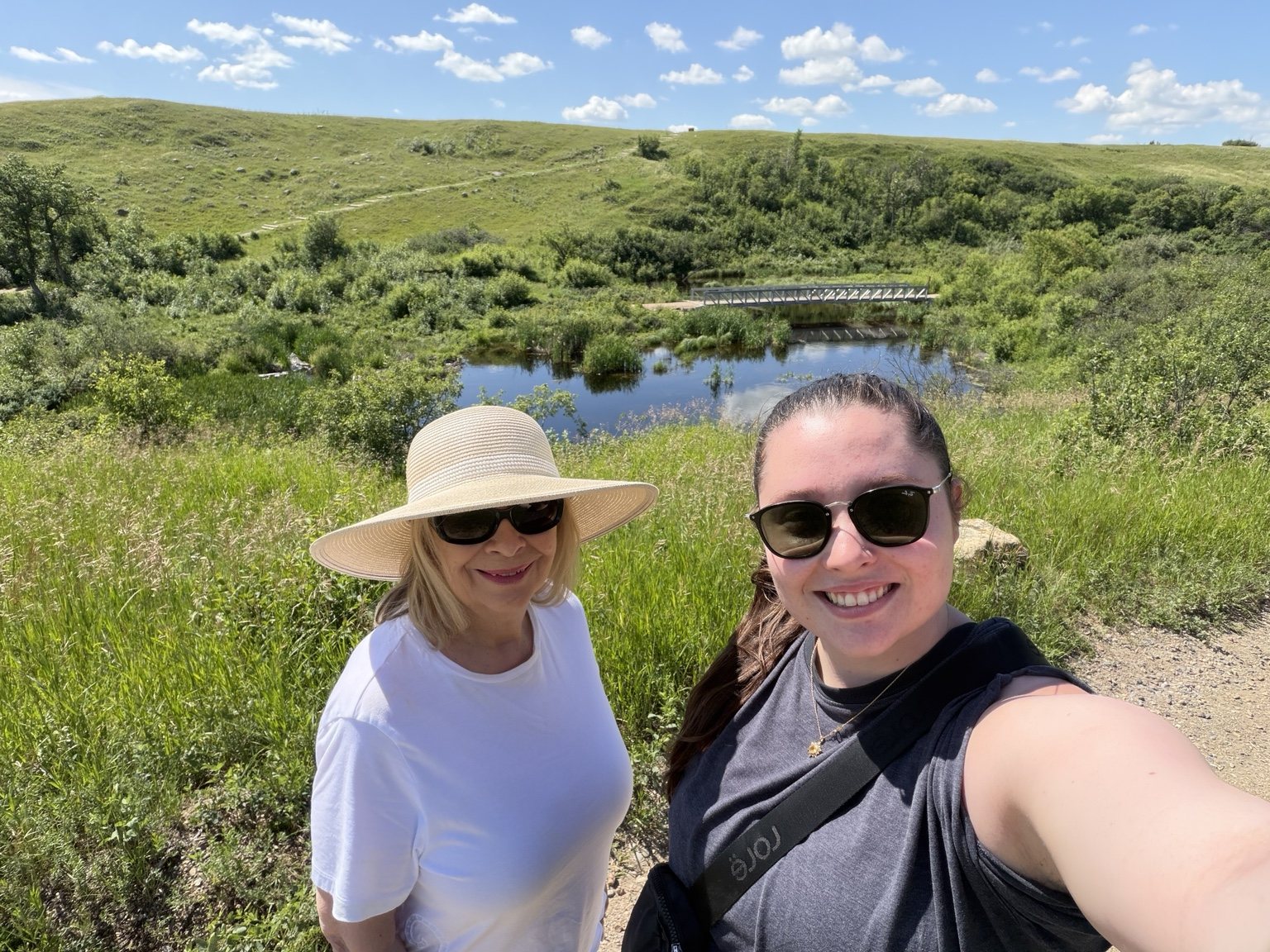Grandmother and granddaughter on the Wanuskewin trail overlooking the valley