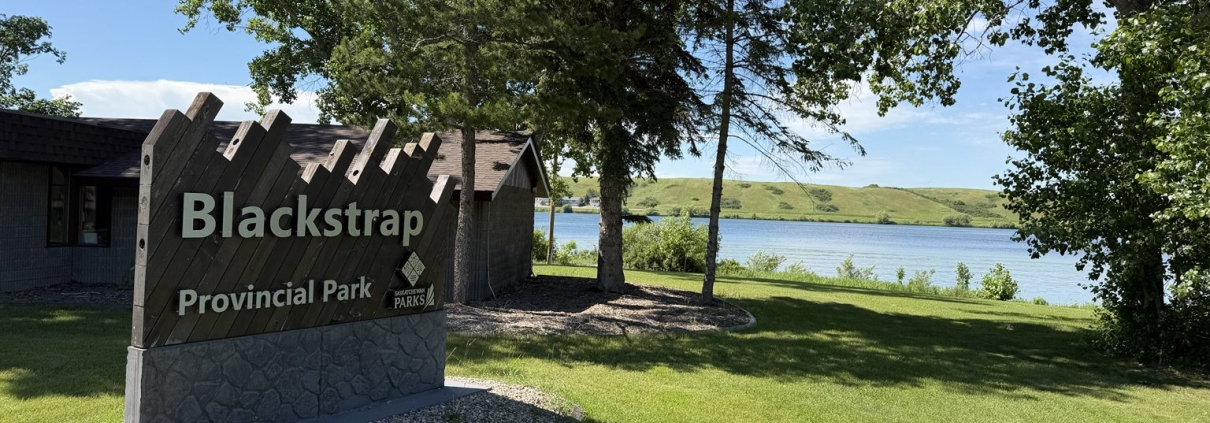 Blackstrap Provincial Park entrance sign with Blackstrap Lake in the background