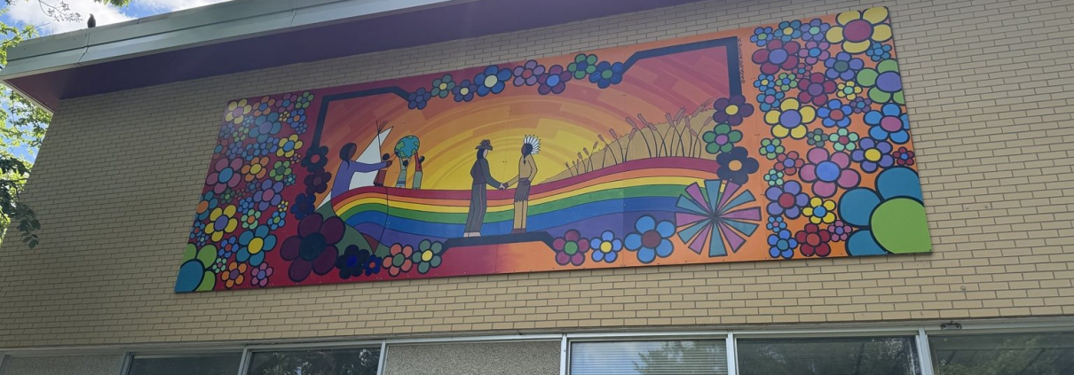 Colourful reconciliation mural created by Kevin PeeAce with Humboldt youth