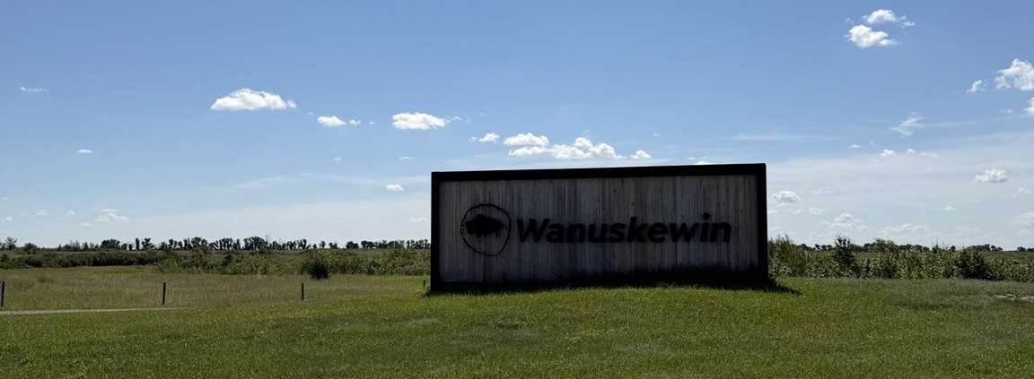 Wanuskewin entrance sign surrounded by open prairie