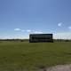 Wanuskewin entrance sign surrounded by open prairie