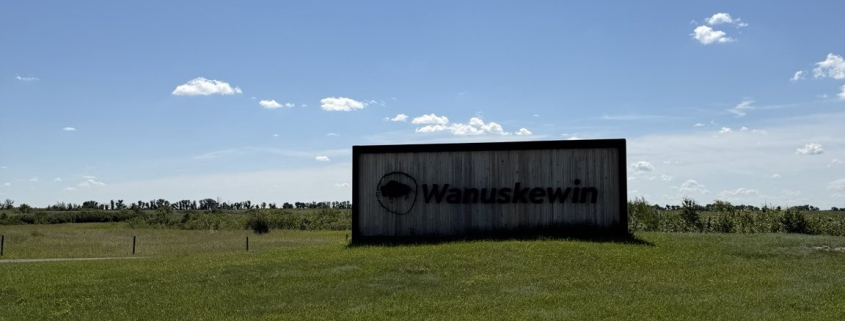 Wanuskewin entrance sign surrounded by open prairie